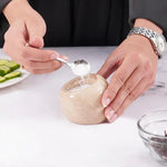 Spoon lifting pink salt from a verona marble salt cellar held steady on a countertop, 3 inches wide and tall