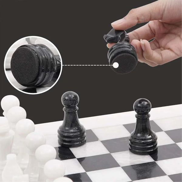 Black marble chess piece lifted showing individual felt bottom — RADICALn white and black marble chess set 15 inch