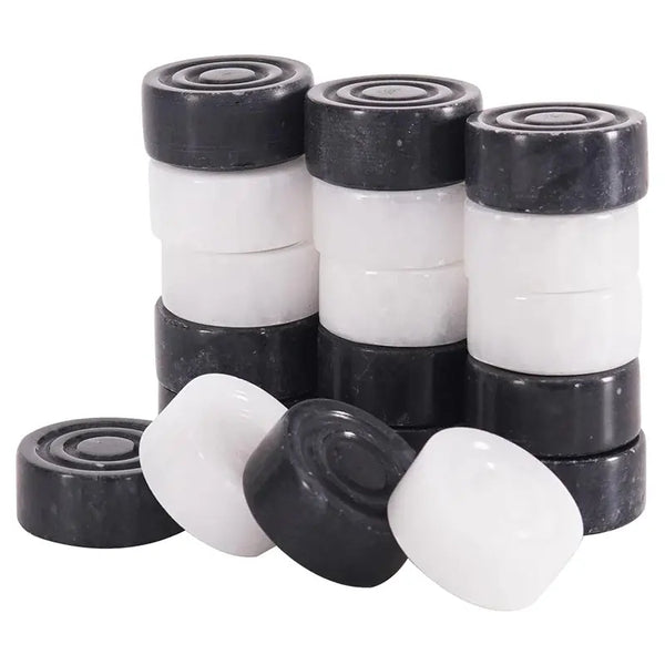Black and white marble checkers pieces stacked — showing stackable natural stone disc construction by RADICALn