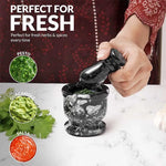 Black zebra marble mortar and pestle used to grind fresh herbs for pesto, guacamole and salsa