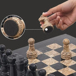 Fossil coral marble chess piece lifted showing individual felt bottom — RADICALn black and fossil coral marble chess set 15 inch