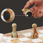 Green onyx on marble chess piece lifted showing individual felt bottom — RADICALn green onyx and white marble chess set 15 inch