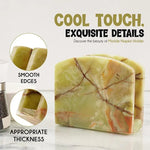 Green onyx marble napkin holder detail showing smooth edges and thickness beside a pepper mill