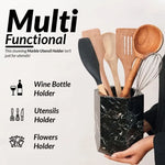 Hexagon black marble utensil holder held in hand, doubling as a wine bottle and flower holder
