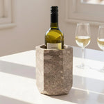 Oceanic hexagon marble wine chiller holding a white wine bottle beside two filled glasses