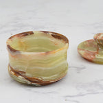 Elegant marble salt cellar with lid and spoon, perfect for maintaining the freshness of salt.