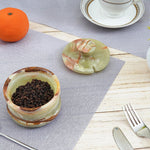 Elegant marble salt container with spoon on a dining table, enhancing your table setting.
