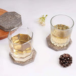 Oceanic octagon marble coasters under two whiskey glasses on a white table