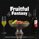 Oceanic marble footed fruit bowl on a pedestal base holding fruit, styled with a wine bottle and glass