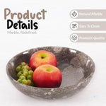 Oceanic marble fruit bowl holding an apple and an orange, showing the polished natural stone finish