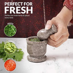 Oceanic marble mortar and pestle used to grind fresh herbs for pesto, guacamole and salsa
