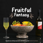 Oceanic marble pedestal fruit bowl holding fruit as a dining centerpiece, styled with a wine bottle and glass