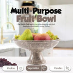 Oceanic marble pedestal fruit bowl raised on a stem holding pear, apple and grapes in a bright kitchen