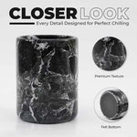Close-up of round black marble wine chiller showing polished stone texture and protective felt bottom