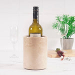 Round verona marble wine chiller holding a wine bottle on a dining table with two glasses