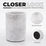 Close-up of round white marble wine chiller showing polished stone texture and protective felt bottom