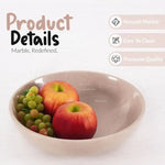 Verona marble fruit bowl holding an apple and an orange, showing the polished natural stone finish