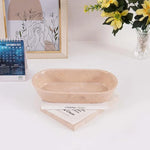 Verona marble oval tray on a desk with books, a calendar and flowers