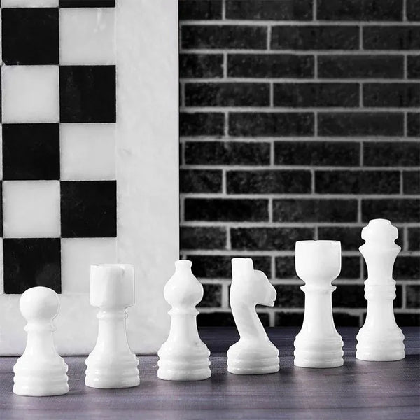 White marble chess pieces lineup — pawn bishop knight rook king queen with white board edge by RADICALn