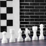 White marble chess pieces lineup — pawn bishop knight rook king queen with white board edge by RADICALn
