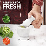 White marble mortar and pestle used to grind fresh herbs for pesto, guacamole and salsa