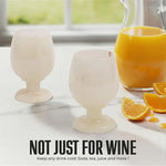 Pair of white onyx marble wine glasses beside an orange juice pitcher for any cold drink