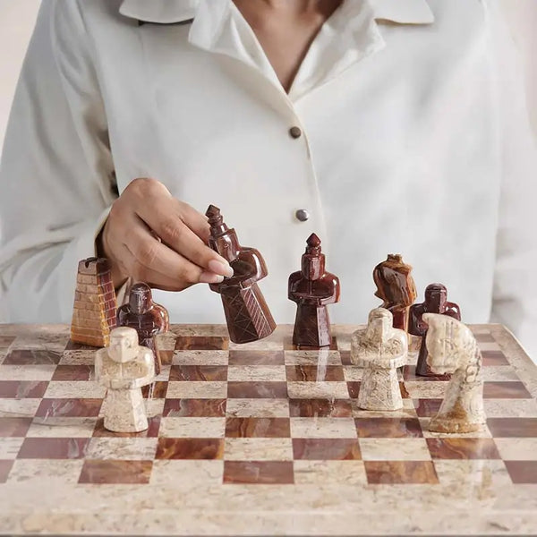 Woman lifting red marble antique bishop figure — coral and red antique marble chess set 15 inch medieval figurative pieces by RADICALn