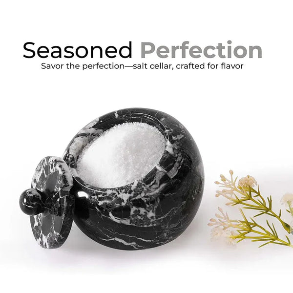 Black marble salt cellar with lid open, filled with pink Himalayan salt, 4 inches wide and 3.5 inches tall
