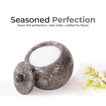 Oceanic marble salt cellar with lid open, filled with pink Himalayan salt, 4 inches wide and 3.5 inches tall