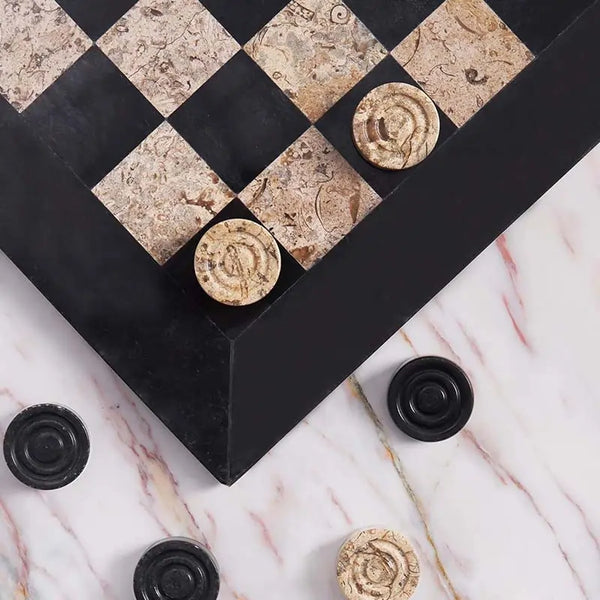 Black and fossil coral marble checkers set 15 inch — board corner detail with black and fossil coral marble disc pieces on marble surface by RADICALn