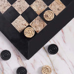 Black and fossil coral marble checkers set 15 inch — board corner detail with black and fossil coral marble disc pieces on marble surface by RADICALn