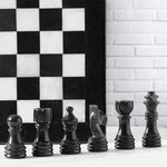 Black marble chess pieces lineup — pawn bishop knight rook king queen with black and white board edge by RADICALn