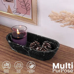 Black marble dough bowl as multi-purpose decor holding a candle and pinecones