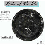 Overhead view of the polished interior of a handmade black marble fruit bowl showing the natural veining