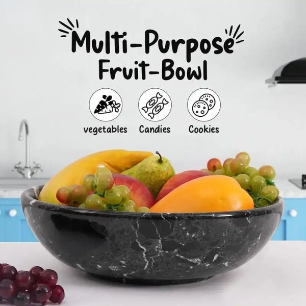 Black marble fruit bowl filled with mango, pear and grapes on a kitchen counter, also suited to vegetables, candies or cookies