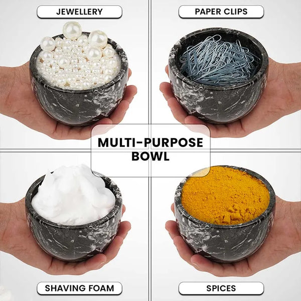 Black marble bowl held in hand holding shaving foam, jewellery, paper clips and spices