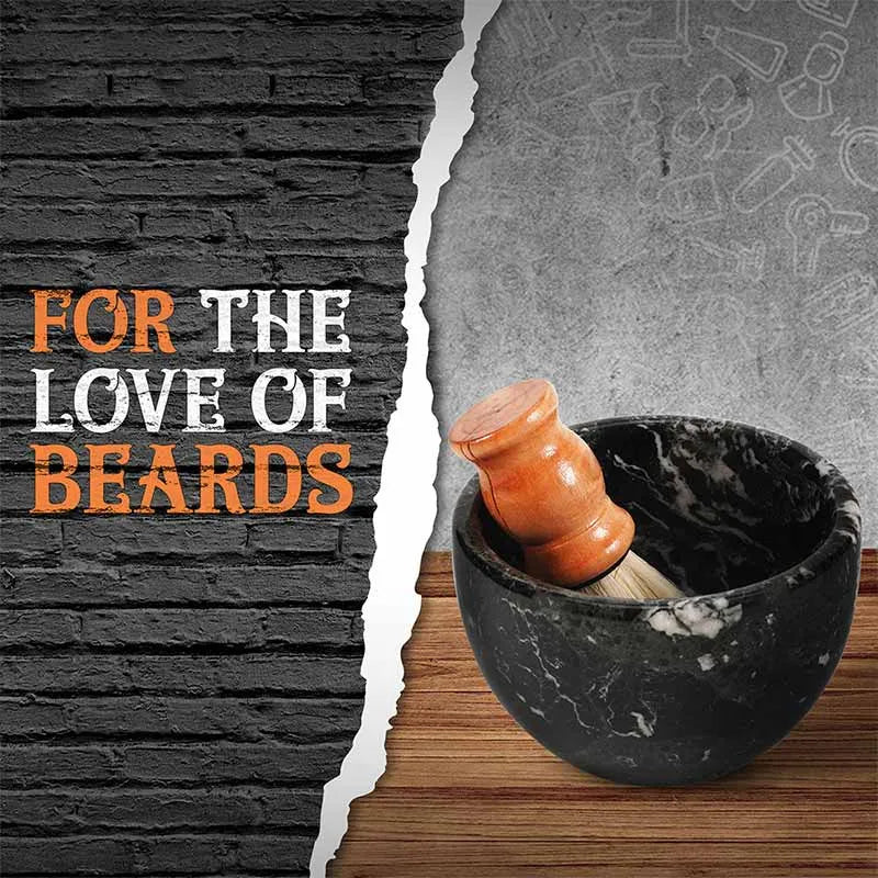 Black marble shaving bowl holding a wooden shaving brush on a wood counter