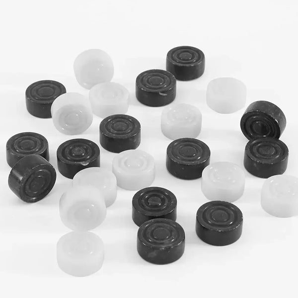 Black and white marble checkers discs overhead view — 32 natural stone pieces scattered by RADICALn