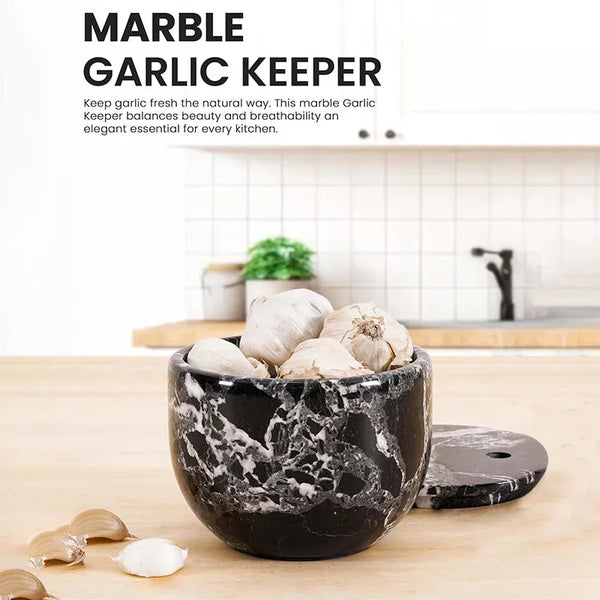 Black zebra marble garlic keeper filled with garlic on a kitchen counter, vented lid beside it