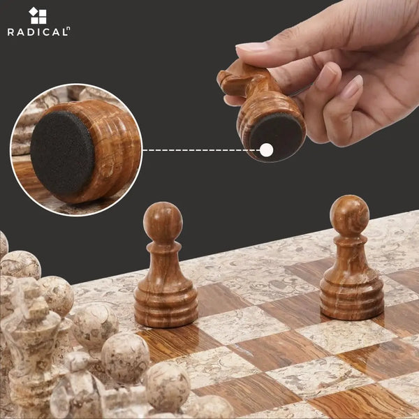 Dark brown marble chess piece lifted showing individual felt bottom — RADICALn white and black marble chess set 15 inch