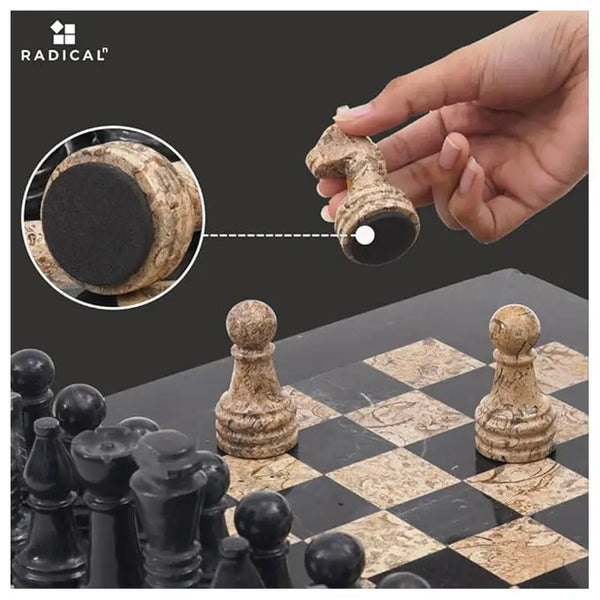 Fossil coral marble chess piece lifted showing individual felt bottom — RADICALn white and black marble chess set 15 inch