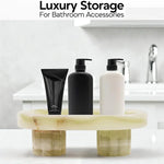 Green onyx footed marble tray holding pump bottles as bathroom storage by a sink