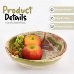 Green onyx marble fruit bowl holding an apple and an orange, showing the polished natural stone finish