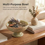 Green onyx marble pedestal bowl used as an entryway key holder with car keys and dried flowers on a console table