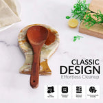 Green onyx marble spoon rest holding a wooden ladle on a countertop