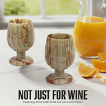 Pair of green onyx marble wine glasses beside an orange juice pitcher for any cold drink