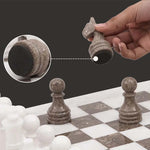 Grey oceanic marble chess piece lifted showing individual felt bottom — RADICALn black and fossil coral marble chess set 15 inch