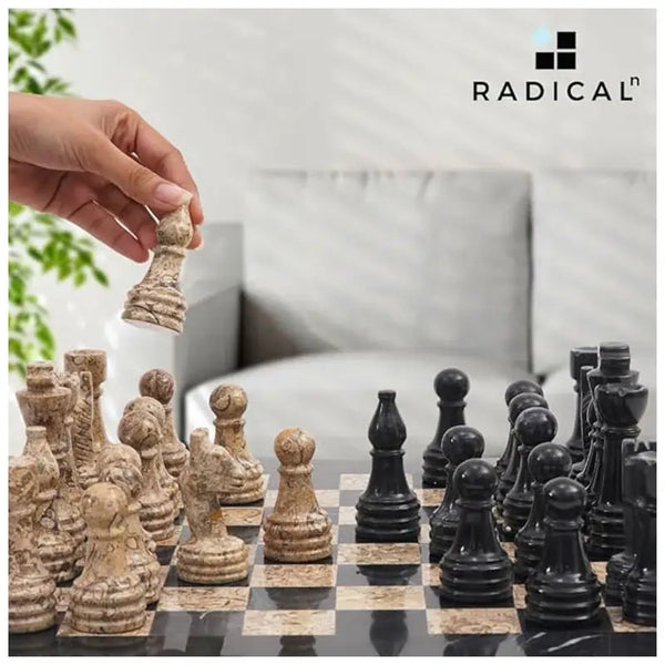 Hand lifting fossil coral marble rook piece — black and fossil coral marble chess set 15 inch standard set in home living room by RADICALn