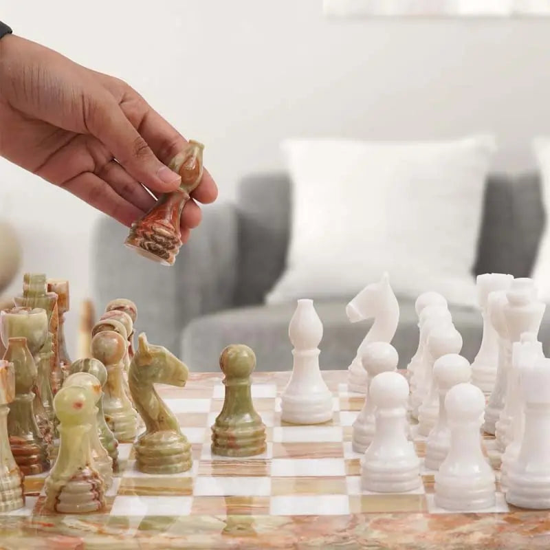 Hand lifting green onyx knight piece — green onyx and white marble chess set 15 inch in living room by RADICALn