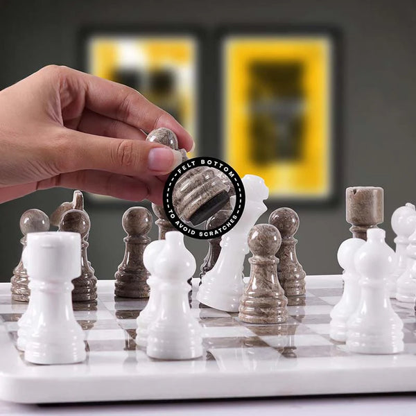Hand lifting grey oceanic chess pawn with felt bottom detail — grey oceanic and white pieces in starting position by RADICALn